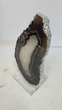 Load and play video in Gallery viewer, Polished Agate Slice with Silver Electroplated Edge on Lucite Base
